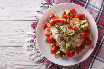 baked flounder with seasonal vegetables. horizontal top view
