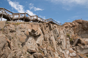 Wood bridge on granite rock and sky