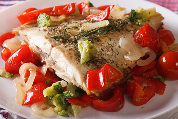 Baked plaice with peppers and broccoli close-up. horizontal
