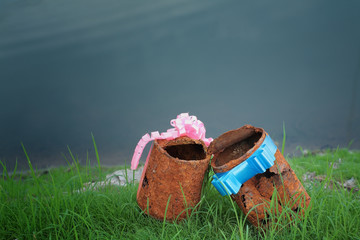 couple of rusty can with ribbon on young grass,like a sign of 
