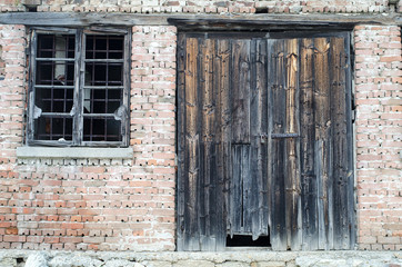 Old wooden gate at brick building
