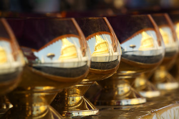 golden pagoda reflect in monk alms bowl.