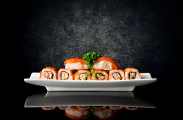 Sushi and rolls in plate - obrazy, fototapety, plakaty