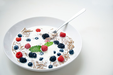 Plate with muesli for breakfast. Isolated on side