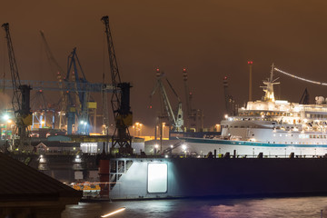 hamburg harbor cranes with ship in construction germany at night