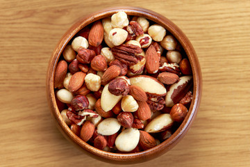 mix nuts in wooden bowls on wooden table