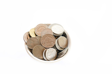 Saving money concept ,putting coins in a cup on a wooden floor.