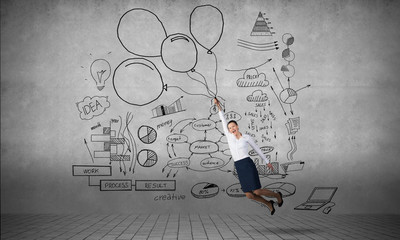 Businesswoman fly on balloons