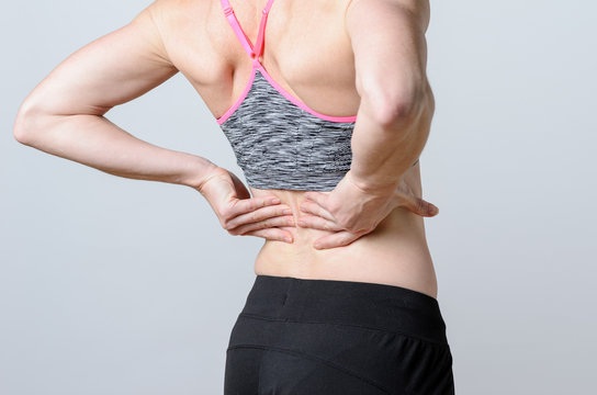Close up Athletic Woman Holding her Injured Back
