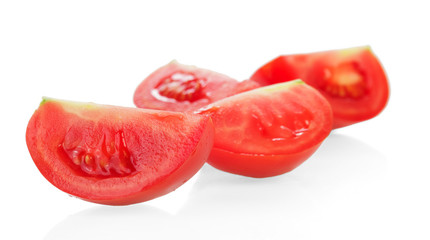 Fresh tomatoes cuting into large pieces isolated on white backgr