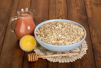 Porridge with honey and juice on wooden