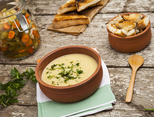 Fresh cream soup in a bowl with bread and seasonal salad