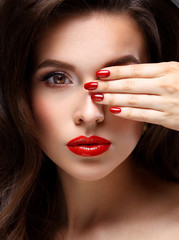 Red Sexy Lips and Nails closeup. Open Mouth. Manicure and Makeup. Make up concept. Half of Beauty model girl's face isolated on black background