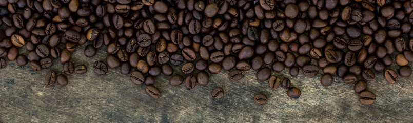 Coffee beans on wood texture background