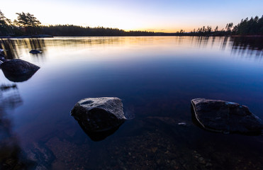 view over lake before the sunrises with rocks in the lake