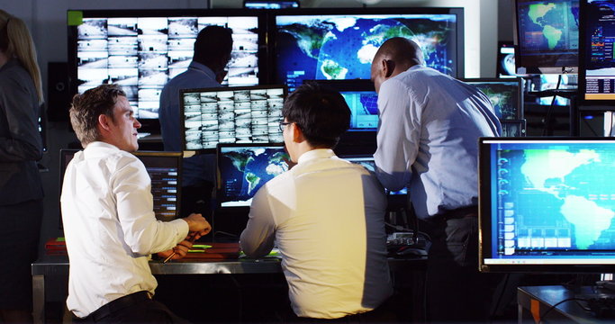  Security & surveillance team working in a busy system control room.