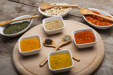Powder spices on spoons and bowl