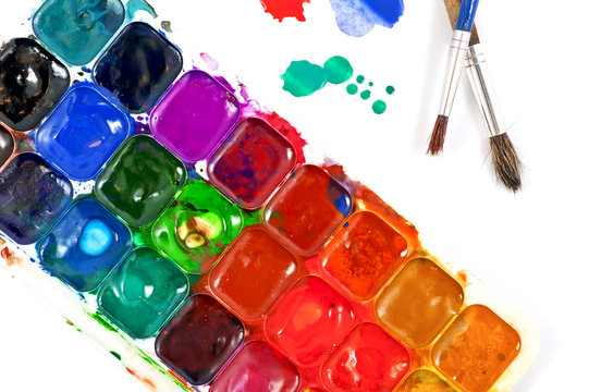 Watercolor paints and brushes isolated on a white background