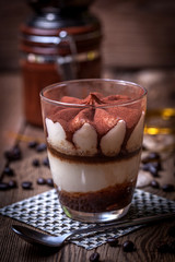 Tiramisu in a glass cup.