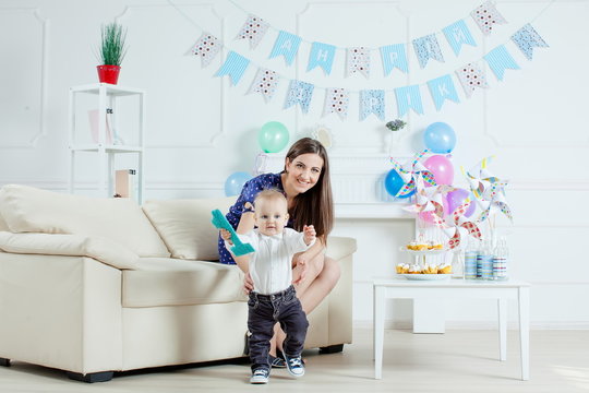 Portrait of mother and baby with birthday cake