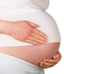 Woman hugging her pregnant belly on white