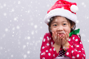 Kid in Christmas Costume with Santa Claus Hat with Snow