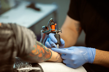 Tattooist makes a tattoo. Closeup