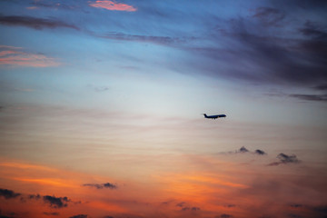 Sunset dramatic sky clouds and airplane