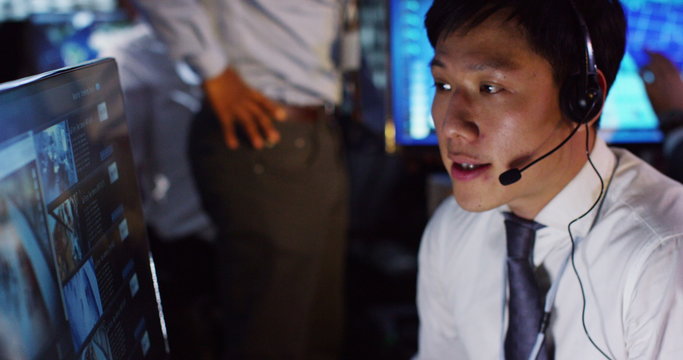  Security & surveillance team working in a busy system control room.