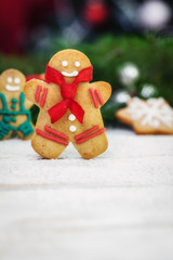 Christmas gingerbread men cookies on white wooden board with copy space