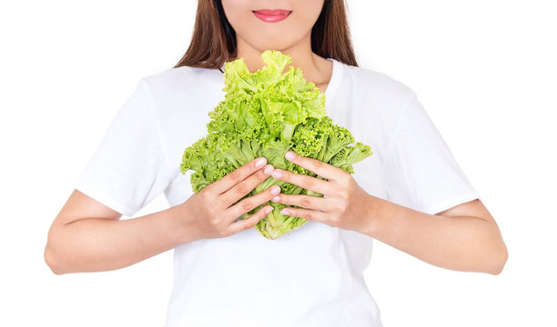 Young woman holding vegetables on white background