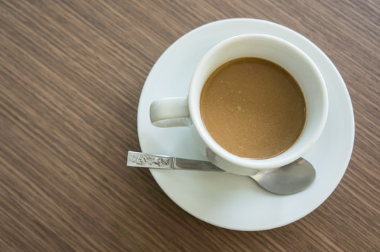 top view, coffee in white cup, wood background