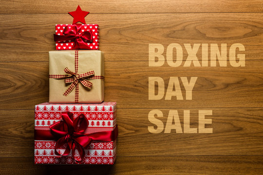 Boxing day Sale concept on wooden background, view from above
