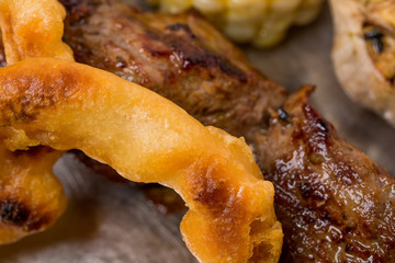 Onions tempura and grilled pork shish kebab.