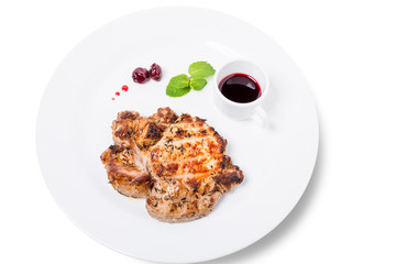 Grilled pork steak with cowberry sauce.