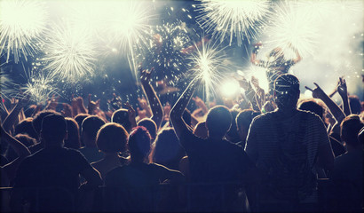 New Year concept - cheering crowd and fireworks