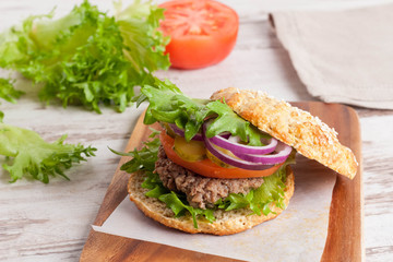 Burger with a vegetarian cutlet and fresh vegetables, close-up