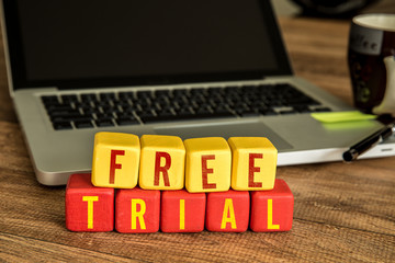 Free Trial written on a wooden cube in a office desk