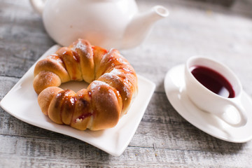 Cup of fruit tea with croissant