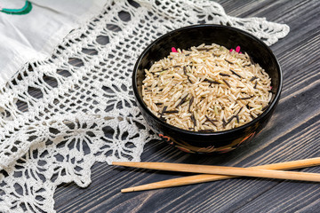 Unpolished rice on wooden background