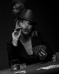 Beautiful young woman playing poker, Black and white.