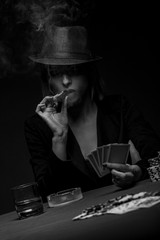 Beautiful young woman playing poker, Black and white.