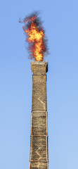 Old brick chimney on fire