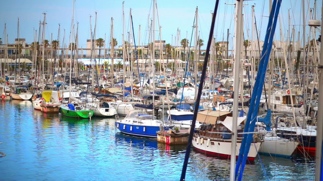 Luxury sailing boats floating near shore in Barcelona