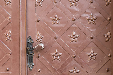 old steel door with decorative pattern and handle