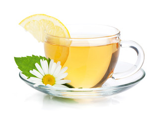 Cup of tea with lemon slice, mint leaves and chamomile flower