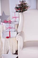 christmas gifts beside a vintage leather armchair