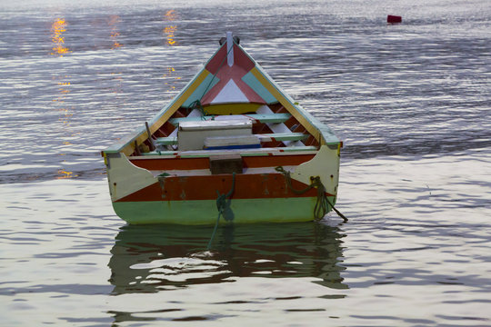 Colorful wooden fisher boat anchored in the bay of Pampatar