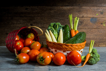Vegetable in basket on brown wooden background