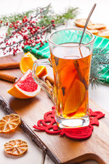 Winter hot drink with spices on wooden table.